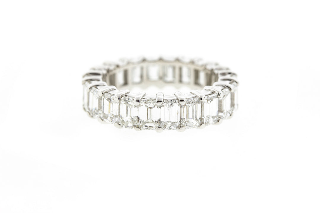 Eternity band in 18K WG with shared prong set (22) Emerald cut diamonds.  D6.65ct.t.w.  Size 6.75