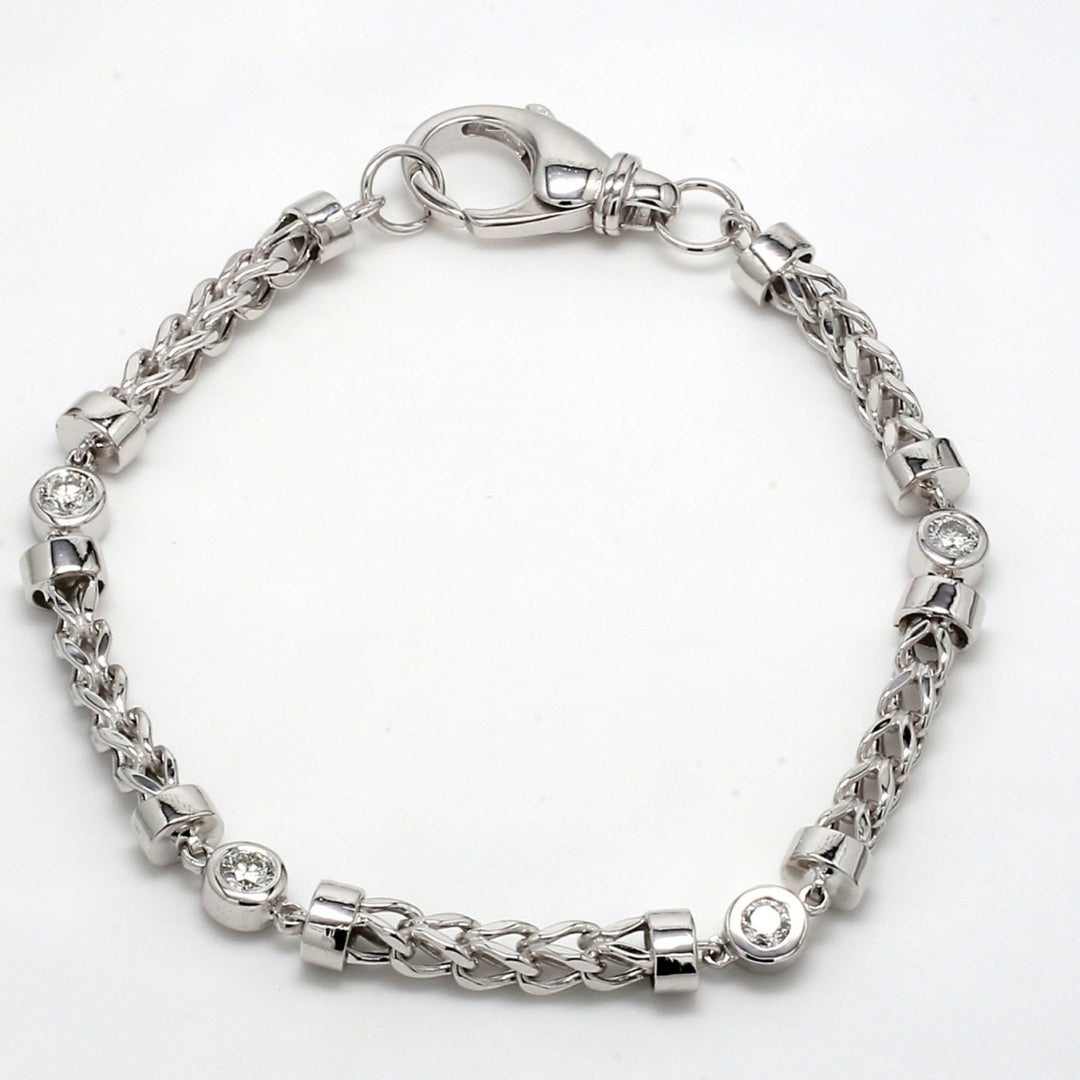 Bracelet with alternating chain and bezel set round diamonds.  D0.80ct.t.w.
