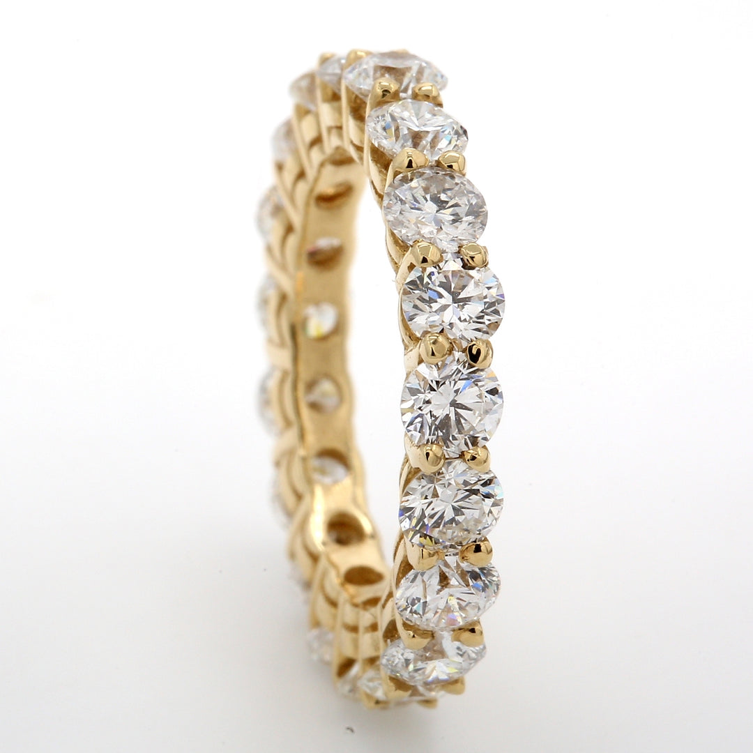 Eternity band in 14K YG with shared prong set (19) round diamonds.  D3.30ct.t.w.  Size 5