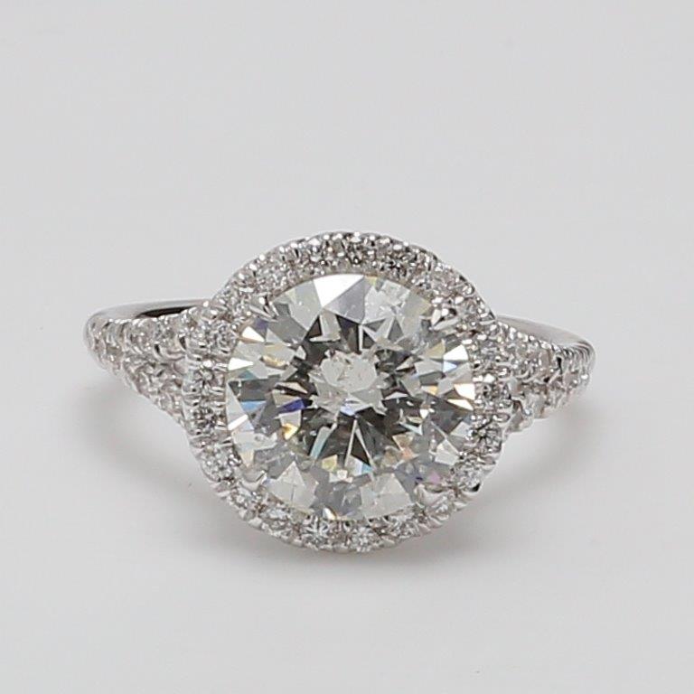 Halo ring in 18K WG with pre-set rounds around USA certified H/SI2 round diamond center.  D3.58ct.t.w.  (Center 3.03ct.)