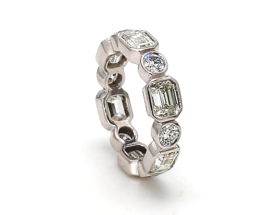 Eternity band with combination bezel set (12) round and emerald cut diamonds.  D3.58ct.t.w.  Size 5