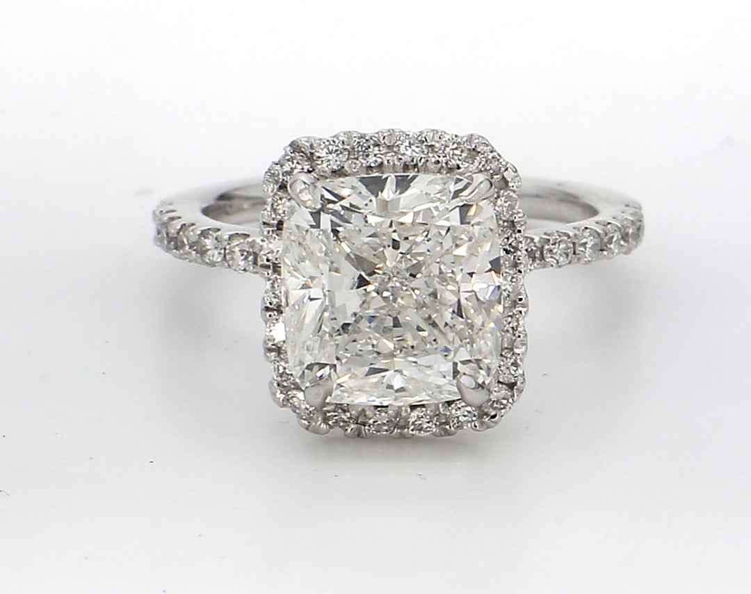 Halo ring platinum with prong set rounds around GIA certified H/VS2 cushion cut diamond center.  D3.97ct.t.w.  (Center 3.51ct.)
