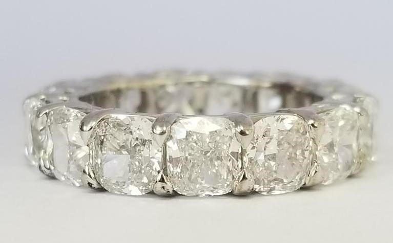Eternity band in platinum with shared prong set GIA certified F/VVS1-VS2 (15) cushion cut diamonds.  D7.71ct.t.w.  Size 5.75