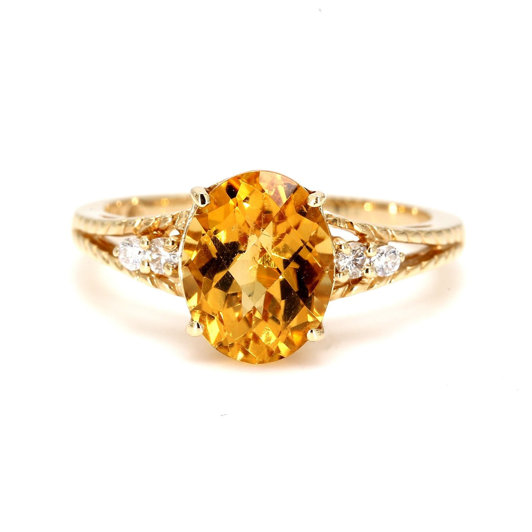 Ring in yellow gold with 4-prong set oval citrine center and round diamond sides.  D0.10ct.t.w.  Citrine 4.00ct.