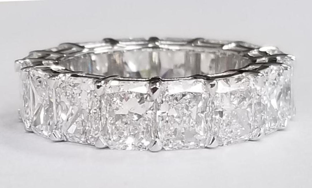 Eternity band in platinum with shared prong set D-F/VVS-VS (16) radiant cut diamonds.  D9.00ct.t.w.  Size 5.25
