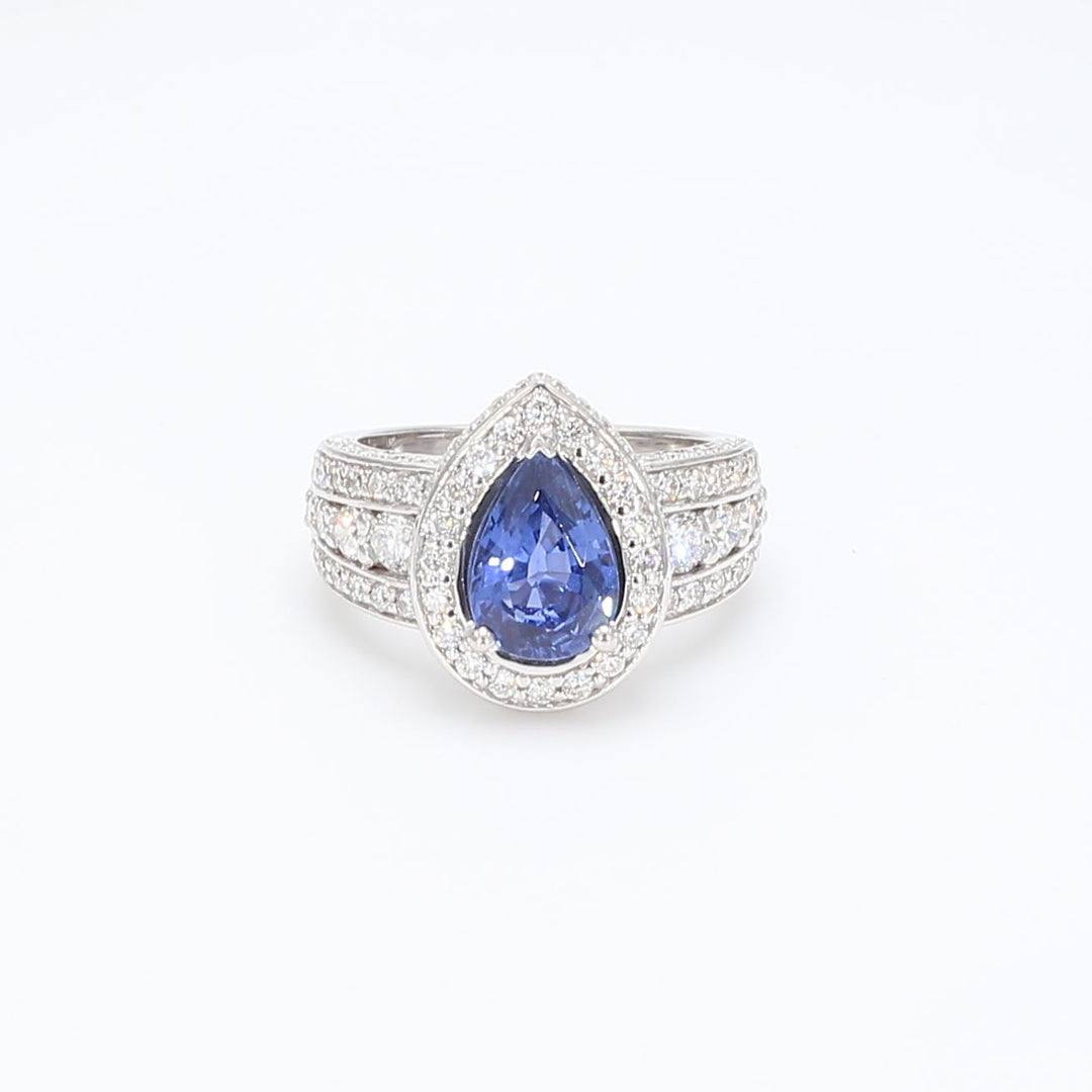 Halo ring with prong set round diamonds & pear shape  tanzanite center.  D2.66ct.t.w.  Tanzanite 1.71ct.