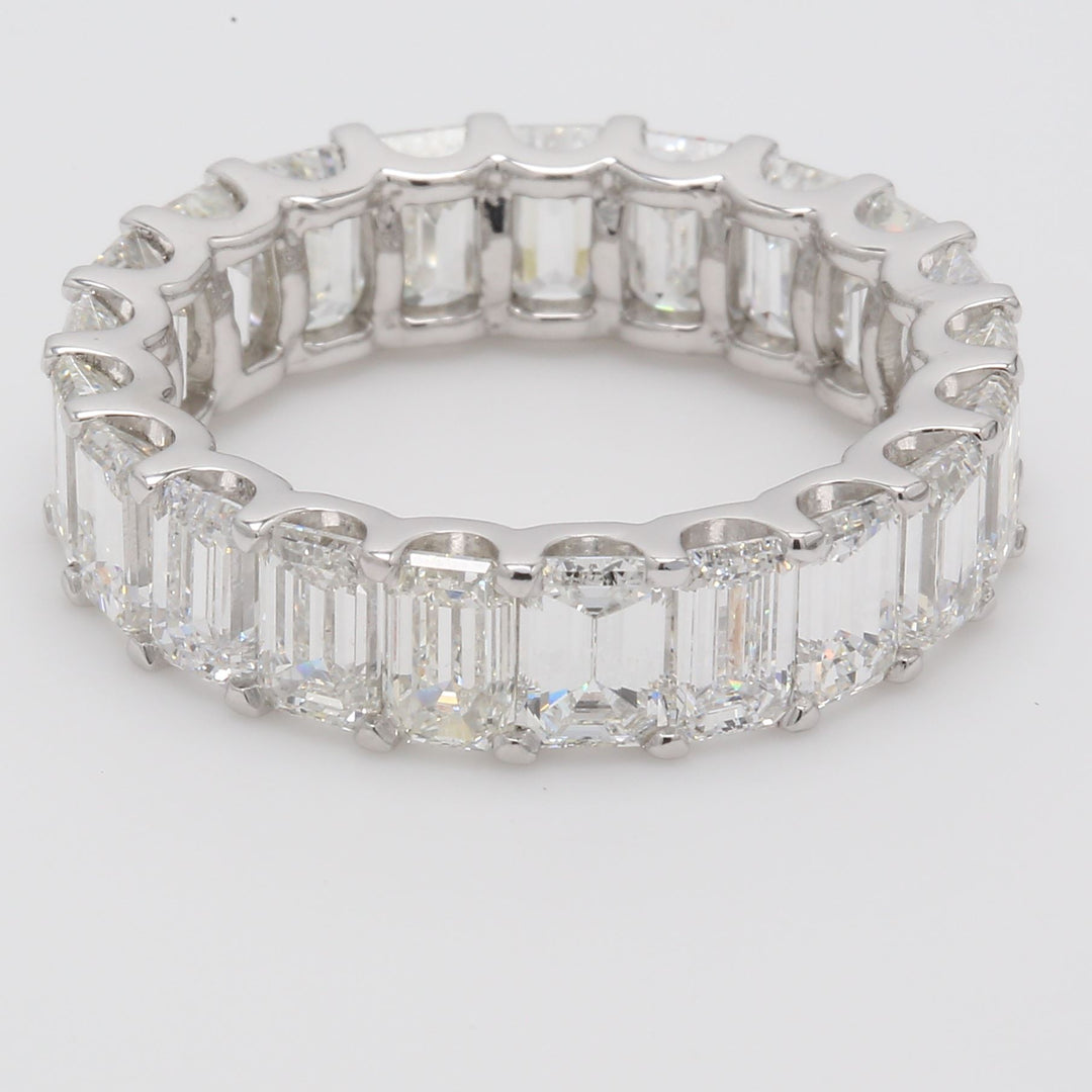 Eternity band in platinum with U-prong set (21) emerald cut diamonds.  D6.83ct.t.w.  Size 6.75