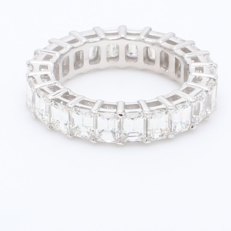 Eternity band in platinum with basket set (22) emerald cut diamonds.  D6.49ct.t.w.  Size 7.75