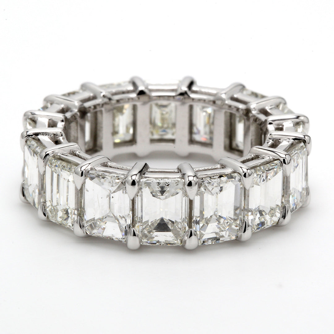 Eternity band in platinum with shared prong set emerald cut diamonds.  D9.05ct.t.w.