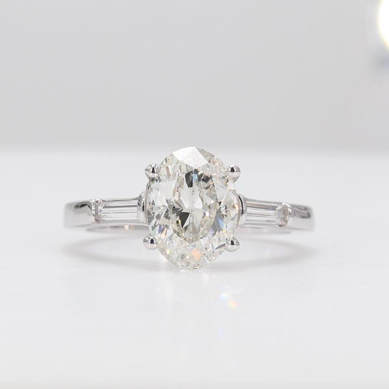 3-stone semi-mount with channel set baguette diamond sides.  D0.20ct.t.w.