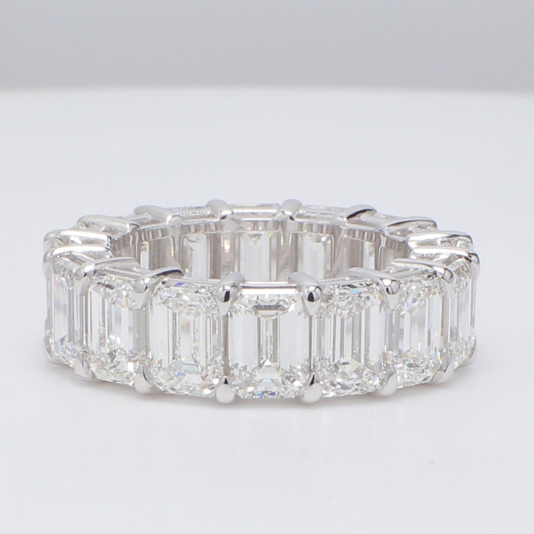 Eternity band in platinum with basket prong set D-F/VVS (16) emerald cut diamonds.  D11.78ct.t.w.  Size 6