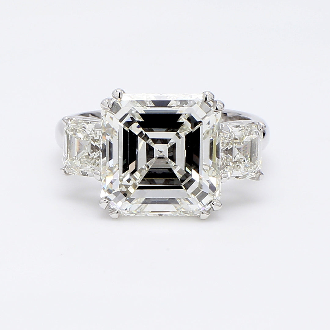 3-stone ring in platinum with 4-prong set GIA certified L/SI1 asscher cut center and asscher cut diamond sides.  D7.54ct.t.w.  (Center 6.10ct.)  Size 6.25