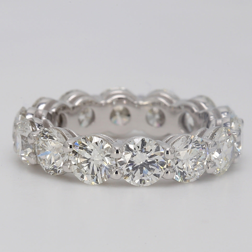 Eternity band in platinum with basket shared prong set G/VS round diamonds.  D6.51ct.t.w.  Size 6.25