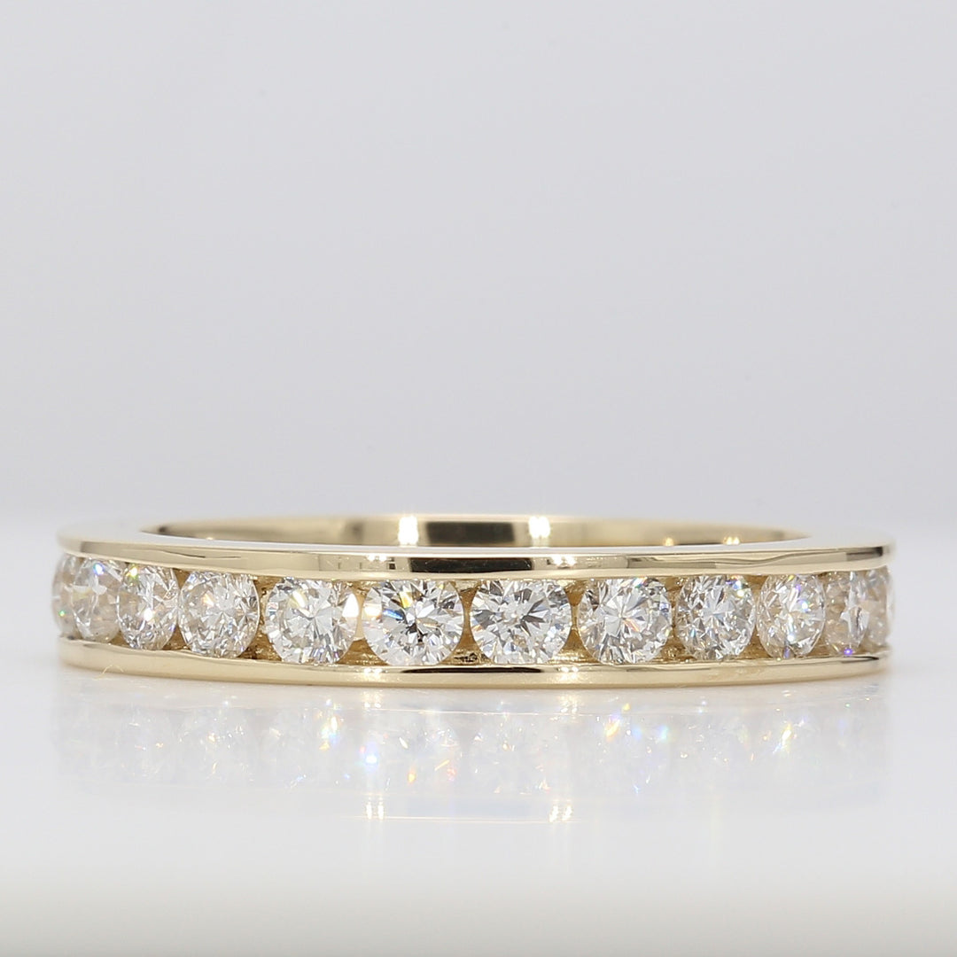 Eternity band in yellow gold with channel set round diamonds.  D1.69ct.t.w.  Size 7