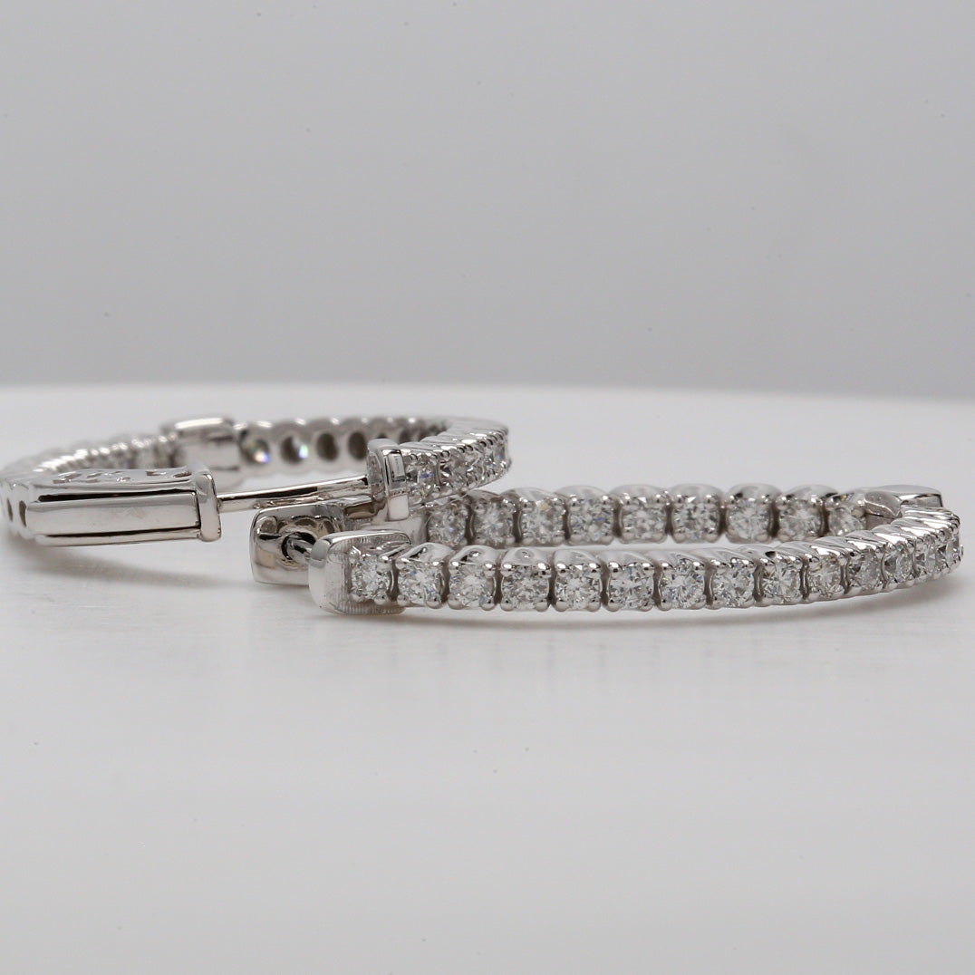 1"" Oval shaped inside out hoop earrings with shared prong set round diamonds.  D0.96ct.t.w.