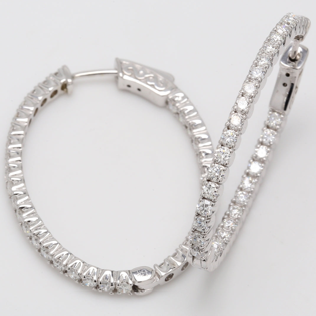 1.5"" Oval shaped inside out hoop earrings with 4-prong set round diamonds.  D2.26ct.t.w.