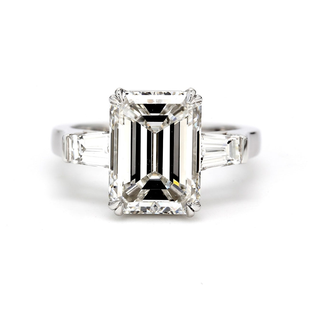 3-stone ring in platinum with double 4-prong set GIA certified F/SI1 emerald cut center stone and tapered baguette diamond sides.  D5.64ct.t.w.  (Center 5.01ct.)