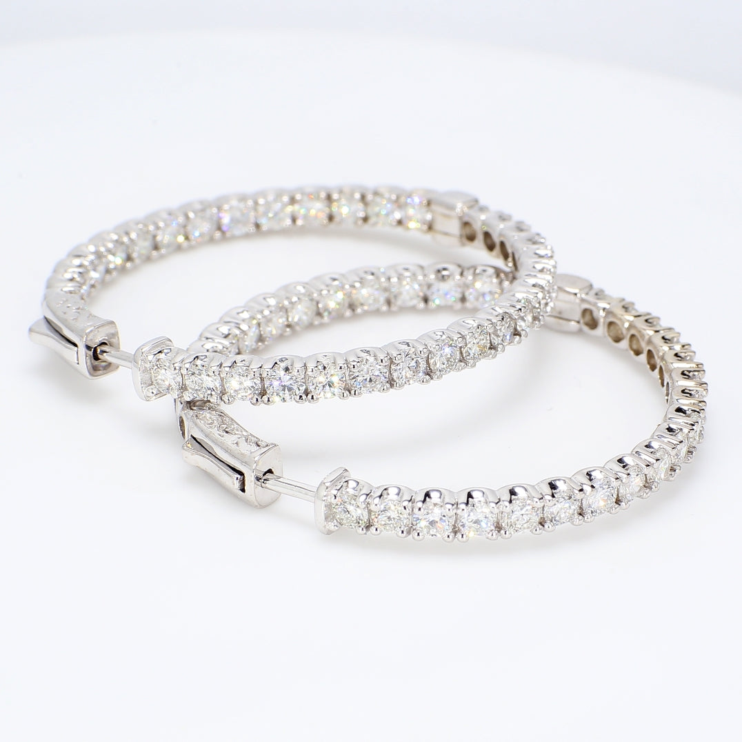 Inside out hoop earrings with prong set round diamonds.  D6.86ct.t.w.