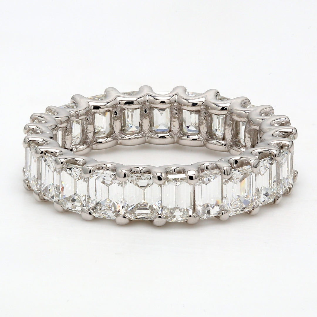 Eternity band in platinum with U-prong set emerald cut diamonds.  D4.52ct.t.w.