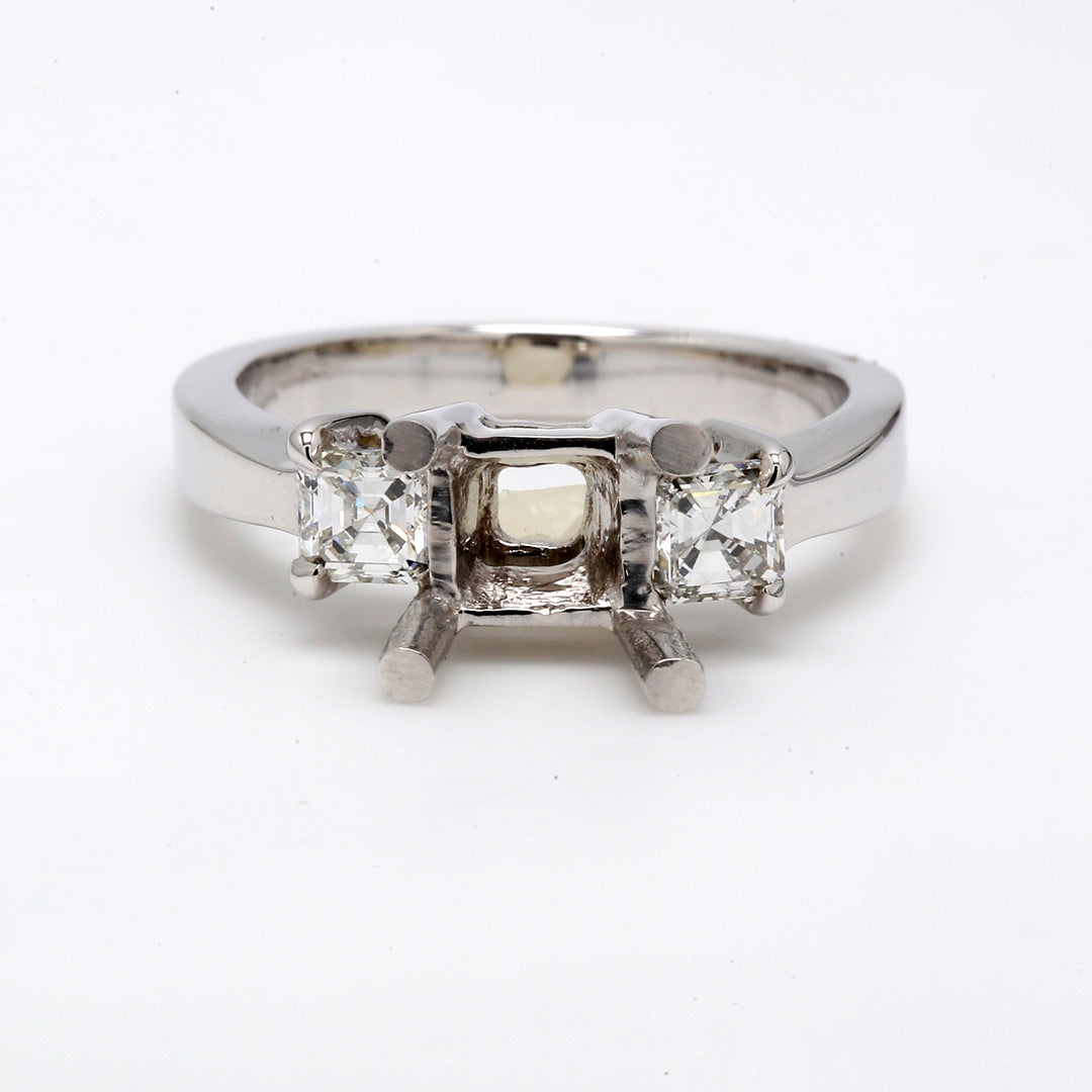 3-stone semi-mount in 18K WG with 4-prong set radiant cut diamonds.  D0.59ct.t.w.