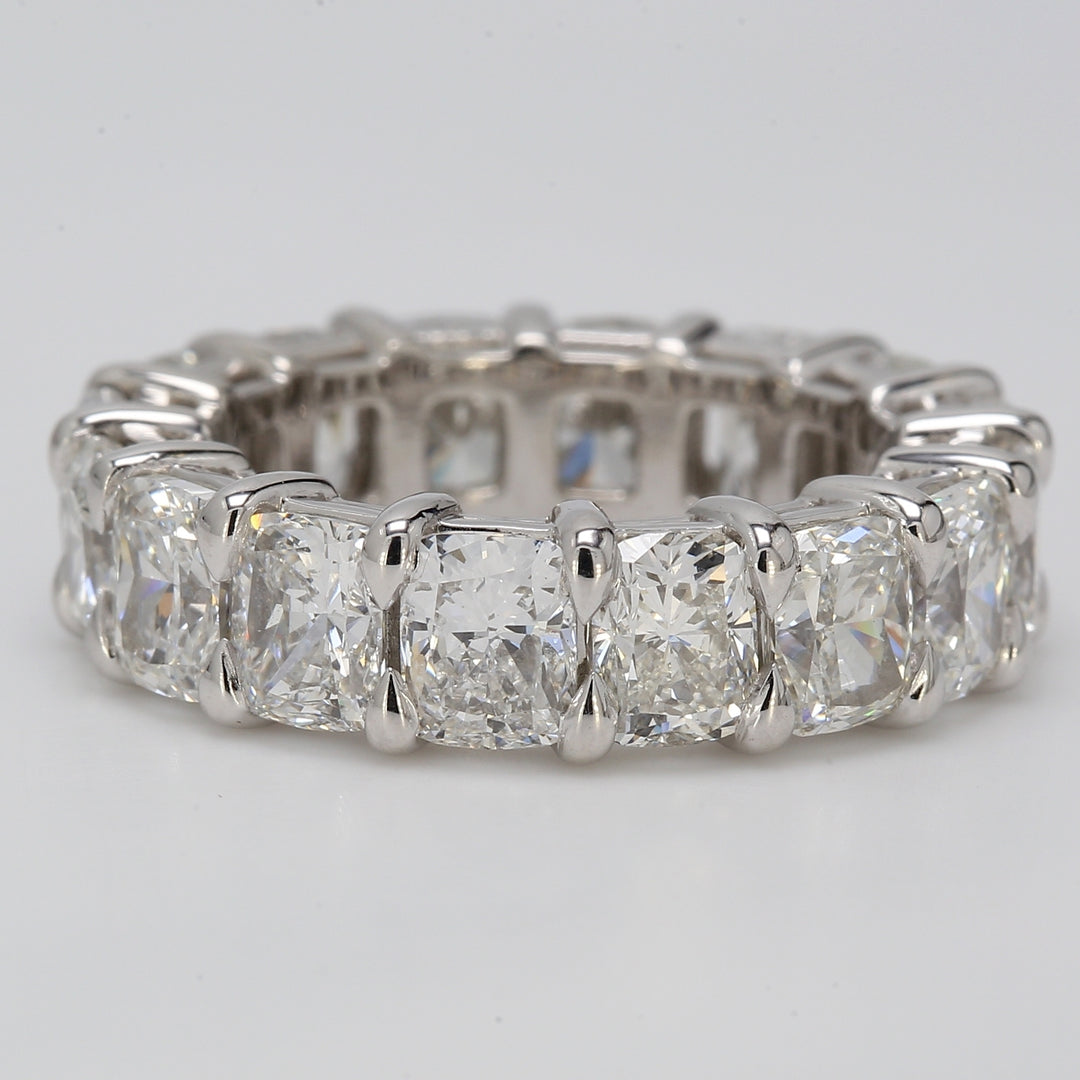 Eternity band in platinum with shared prong basket set elongated F+/VS (16) cushion cut diamonds.  D8.00ct.t.w.  Size 5.25