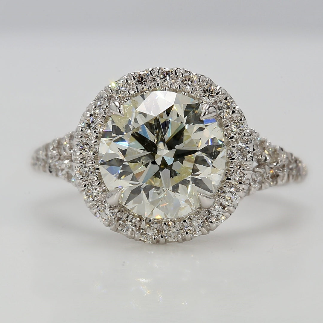 Halo split-shank semi-mount in 18K WG with pre-set round diamonds.  D0.55ct.t.w.