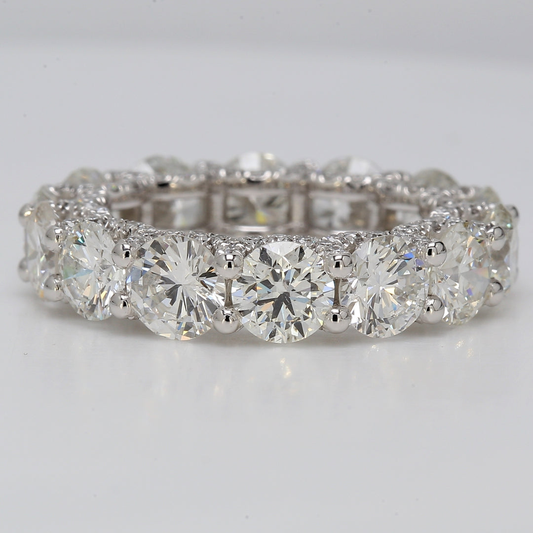 Eternity band in platinum with shared prong set G-H/VS-SI (14) rounds & U-prong set round diamonds on the sides.  D8.36ct.t.w.  Size 6.25