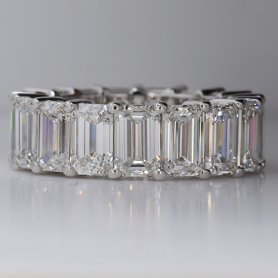 Eternity band in platinum with shared prong basket set GIA certified D-F/VVS-VS (17) emerald cut diamonds.  D12.11ct.t.w.  Size 6.25