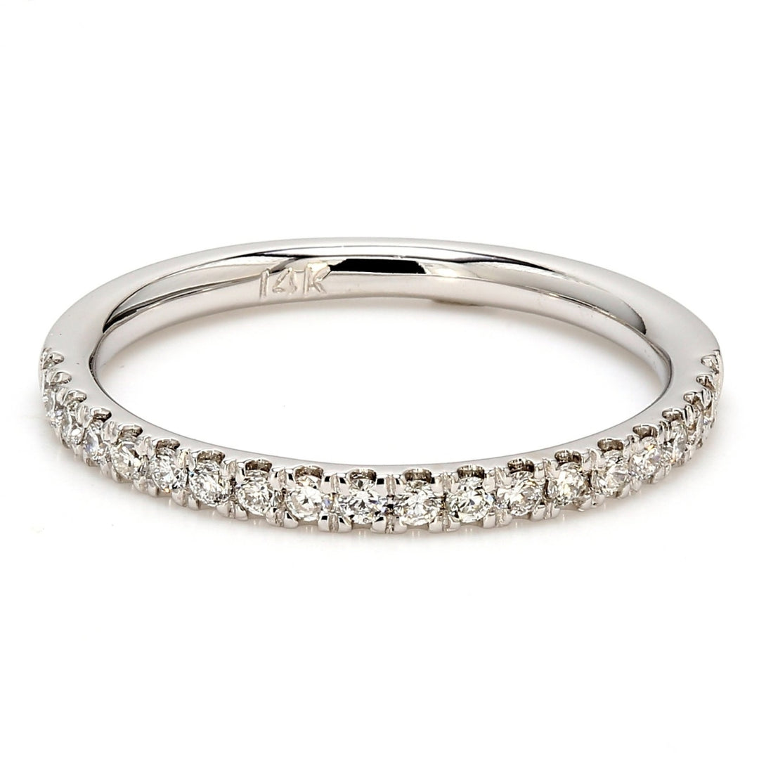 Band with shared prong set (19) round diamonds.  D0.25ct.t.w.  Size 7