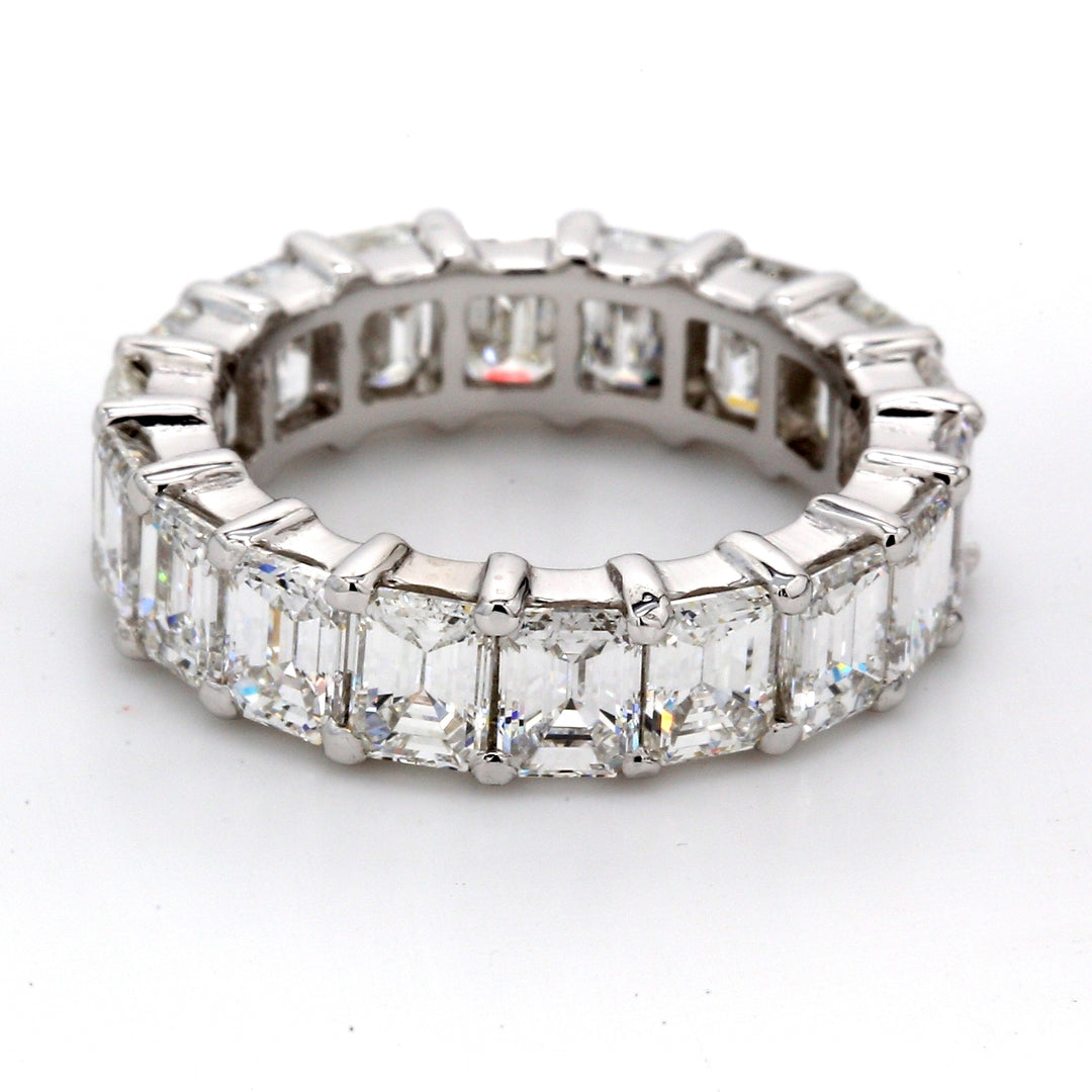 Eternity band in platinum with shared prong set E-F/VVS (18) emerald cut diamonds.  D5.59ct.t.w.  Size 5.25