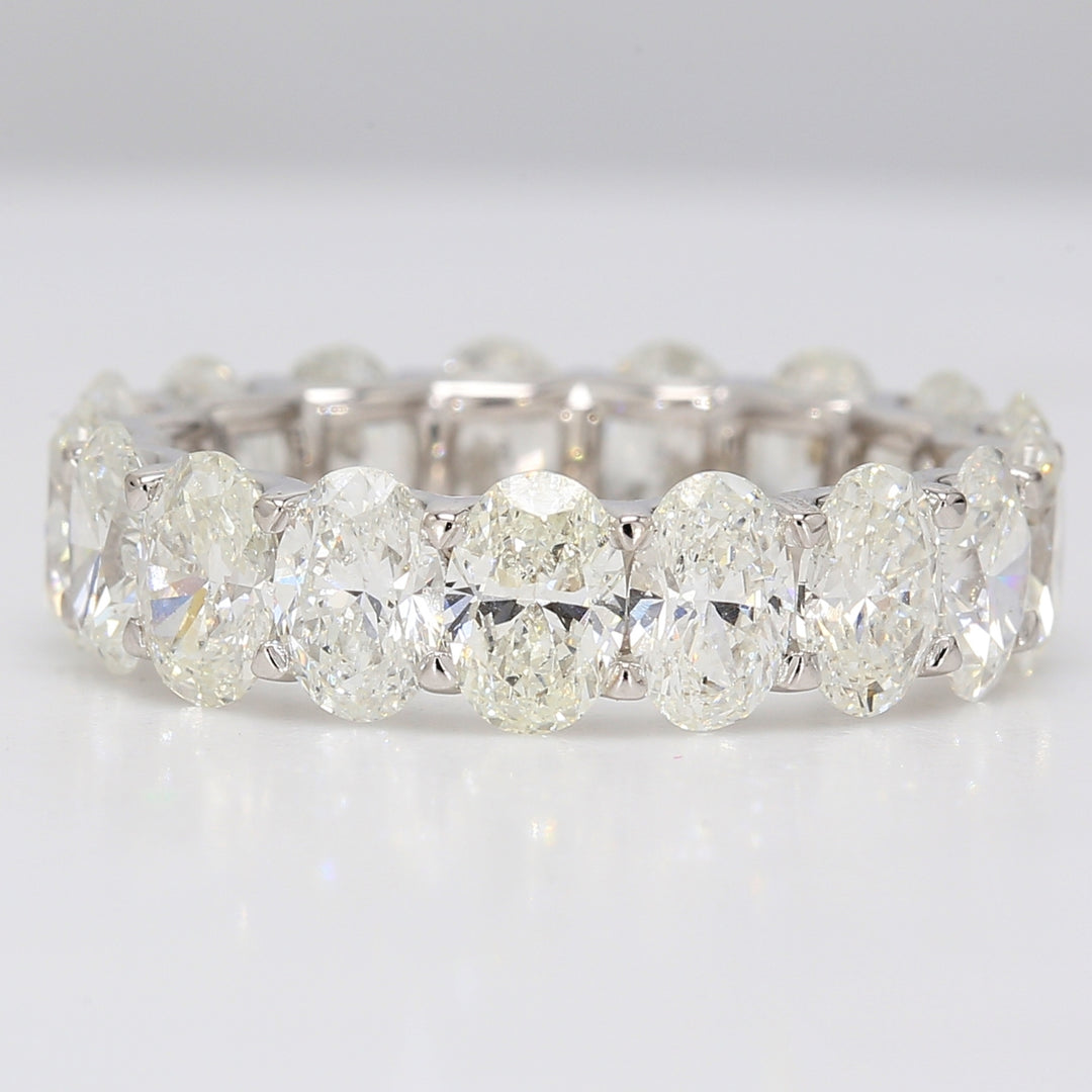 Eternity band in 18K WG with shared U-prong set G/VVS-VS (17) oval diamonds.  D5.54ct.t.w.  Size 6