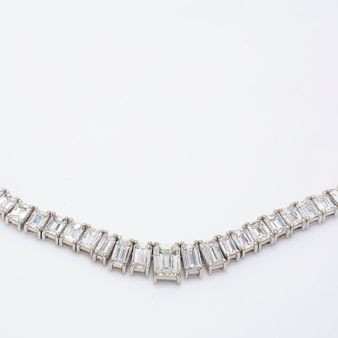 19"" Graduated tennis necklace in platinum with 4-prong set emerald cut diamonds and GIA certified H/SI2 emerald center.  D30.04ct.t.w.  (Center 1.51ct.)