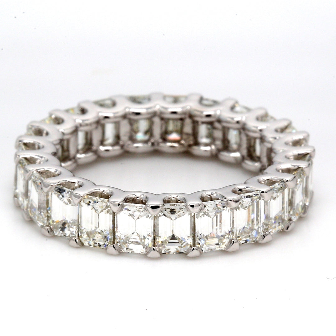 Eternity band in platinum with shared U-prong set (23) emerald cut diamonds.  D4.92ct.t.w.  Size 5.75