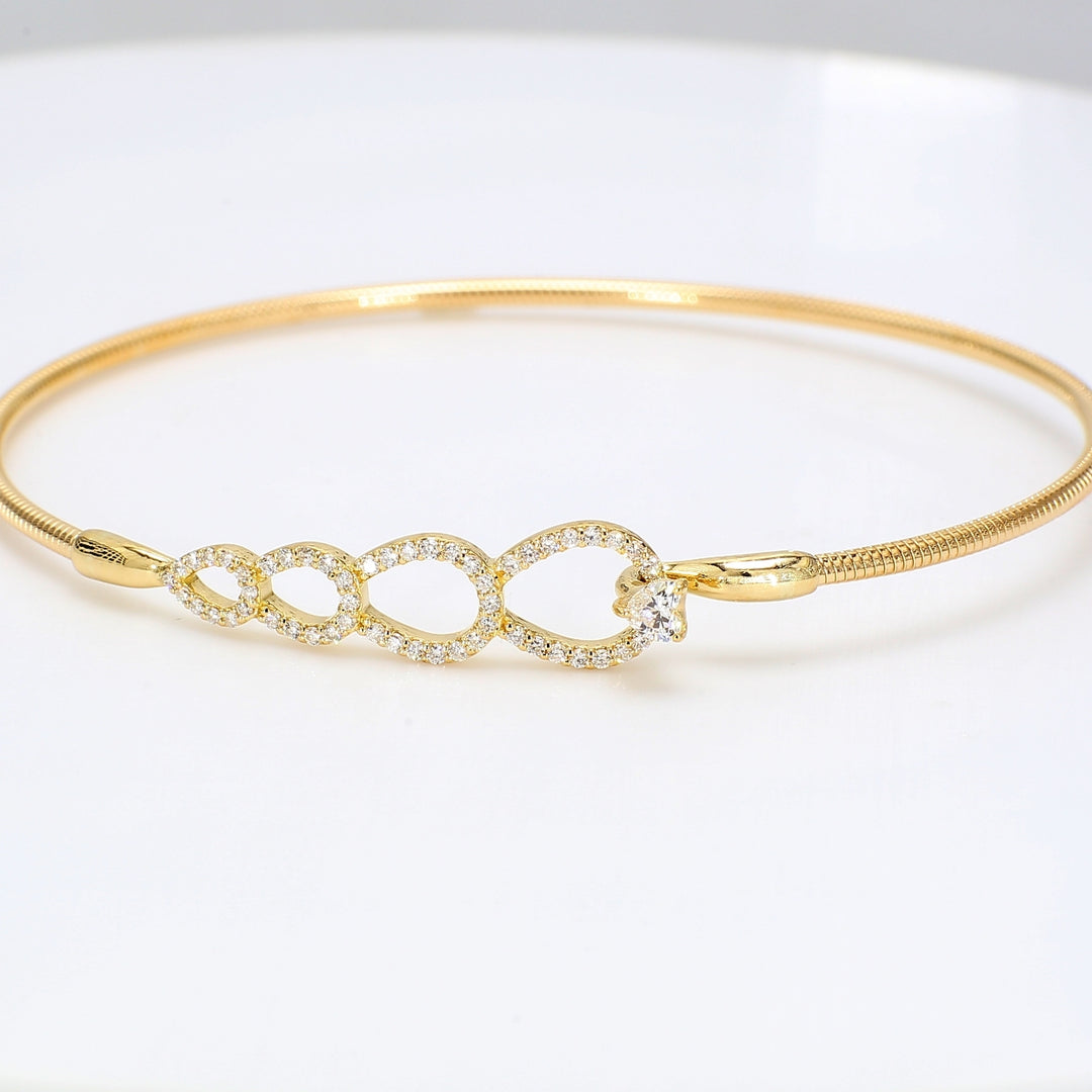 Hook bangle cable style in 18K YG with pre-set rounds & prong set heart shape diamond center.  D0.36ct.t.w.