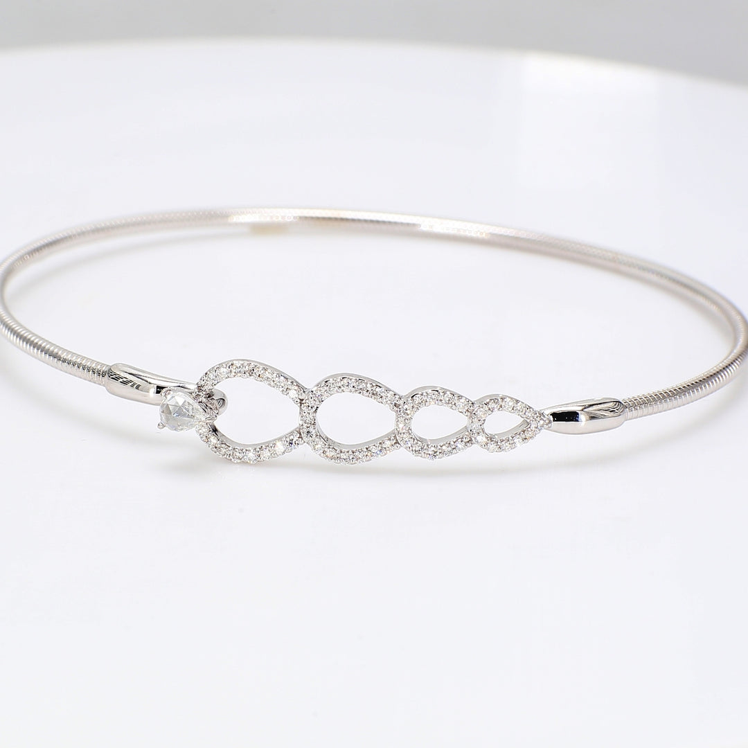 Hook bangle cable style in 18K WG with pre-set rounds & prong set pear shape diamond center.  D0.40ct.t.w.
