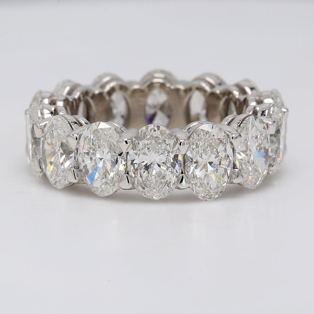 Eternity band in platinum with shared prong basket set GIA certified E-G/SI1-2 (14) oval diamonds.  D9.94ct.t.w.  Size 7