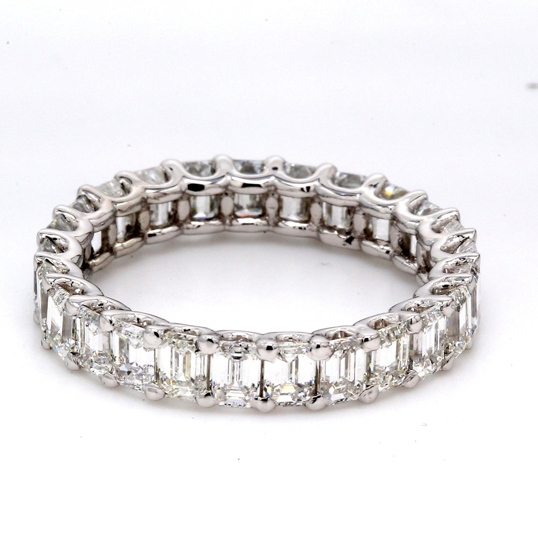 Eternity band in platinum with U-prong set (24) emerald cut diamonds.  D3.62ct.t.w.  Size 5.5