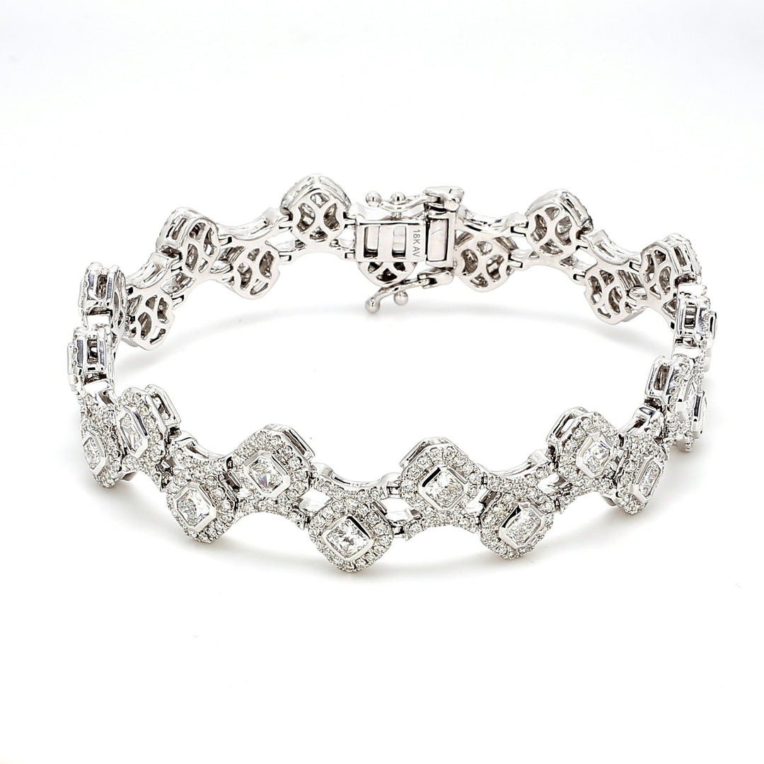 7"" Designer bracelet in 18K WG with halo and pave set rounds around bezel set radiant cut diamonds.  D5.81ct.t.w.