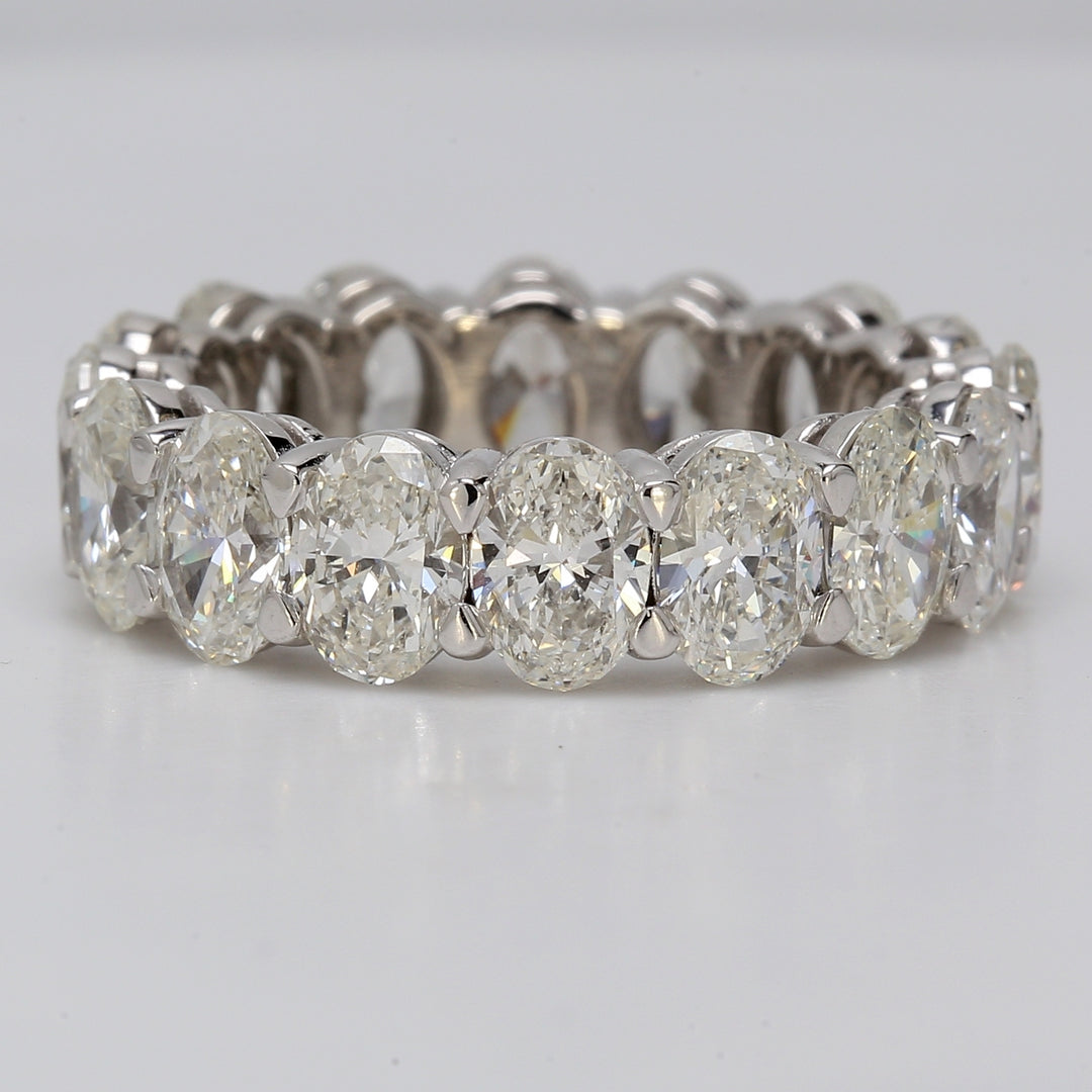 Eternity band in platinum with eagle claw basket set G-H/VS+ (16) oval diamonds.  D6.55ct.t.w.  Size 6.25