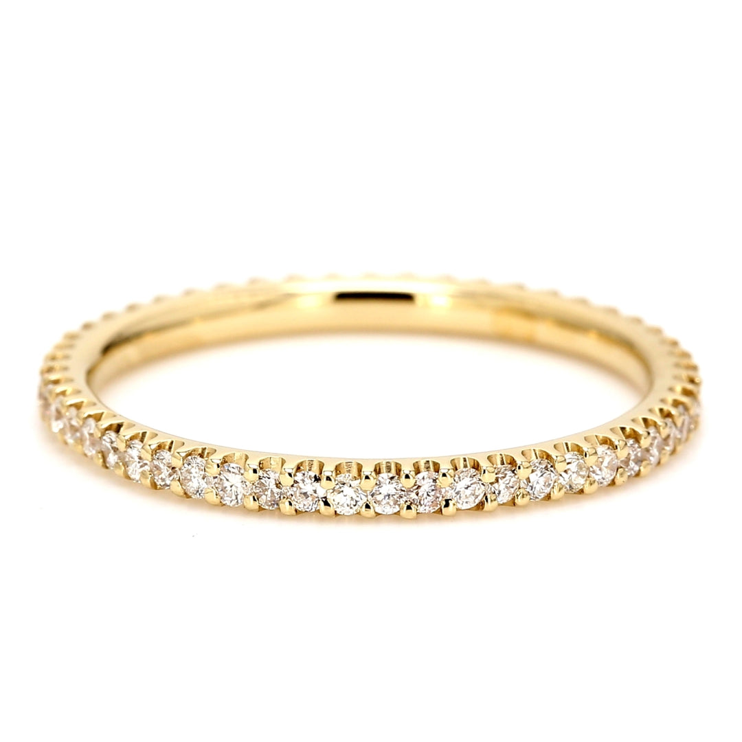 Eternity band in 18k yellow gold with shared U-prong set round diamonds.  D0.44ct.t.w.