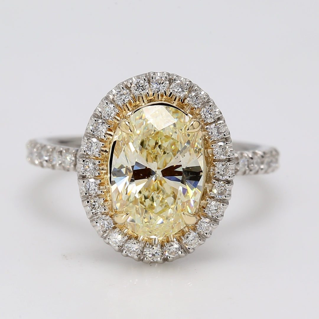 Halo ring in platinum with pre-set rounds around GIA certified FLY/VS2 oval cut diamond center.  D2.42ct.t.w.  (Center 2.05ct.)  Size 5.5