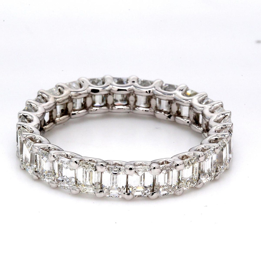 Eternity band in platinum with shared U-prong set emerald cut diamonds.  D4.04ct.t.w.  Size 6.75