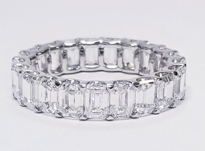 Eternity band in platinum with shared U-prong set (23) emerald cut diamonds.  D5.74ct.t.w.  Size 6.75
