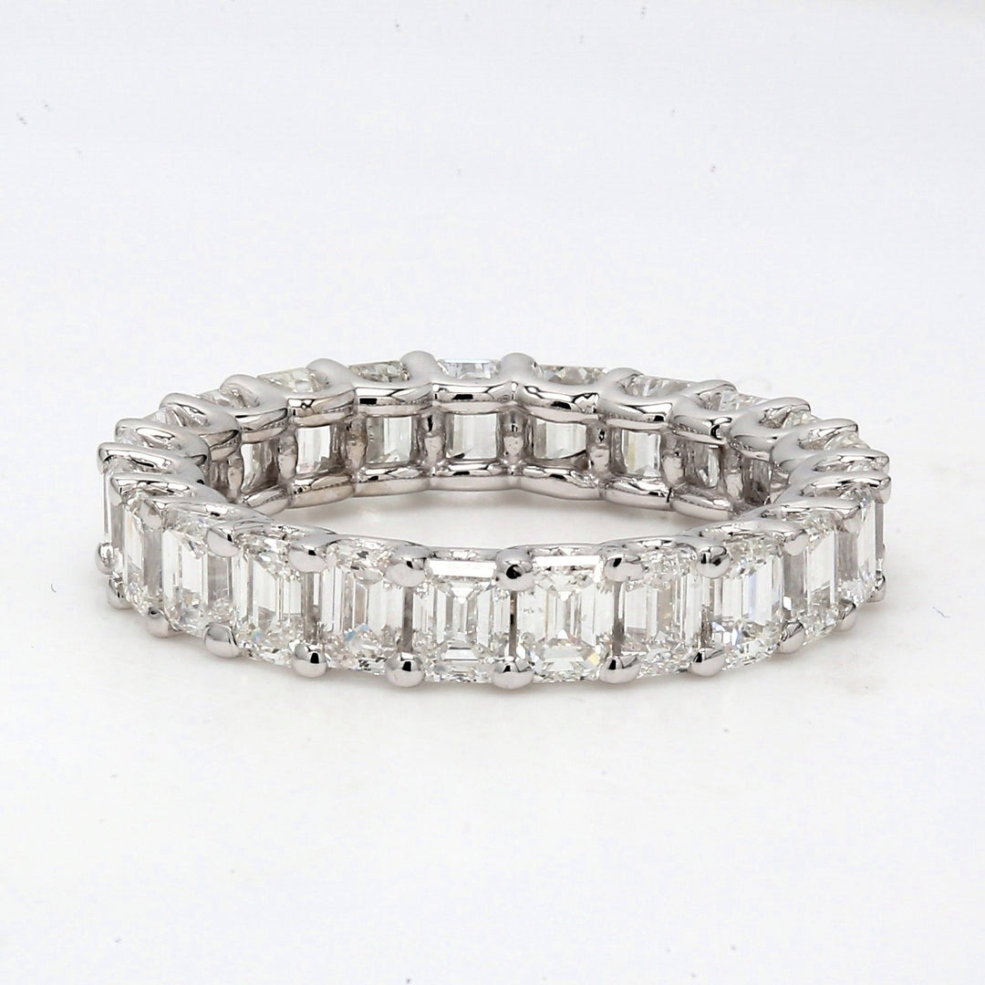 Eternity band in platinum with U-prong set (23) emerald cut diamonds.  D5.29ct.t.w.  Size 5.75