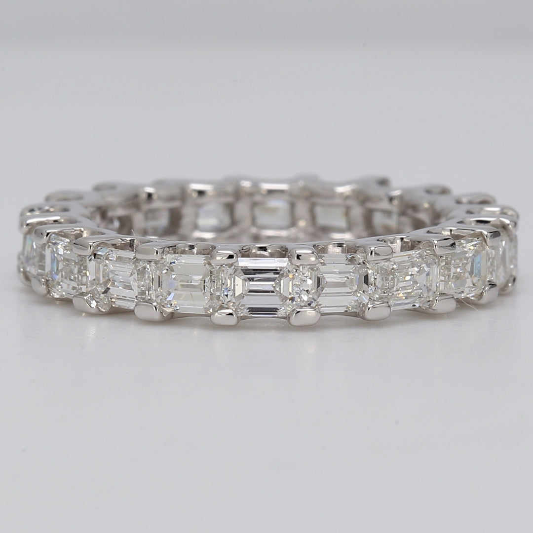 East to west style eternity band in platinum with U-prong set emerald cut  diamonds.  D2.82ct.t.w.  Size 5.5