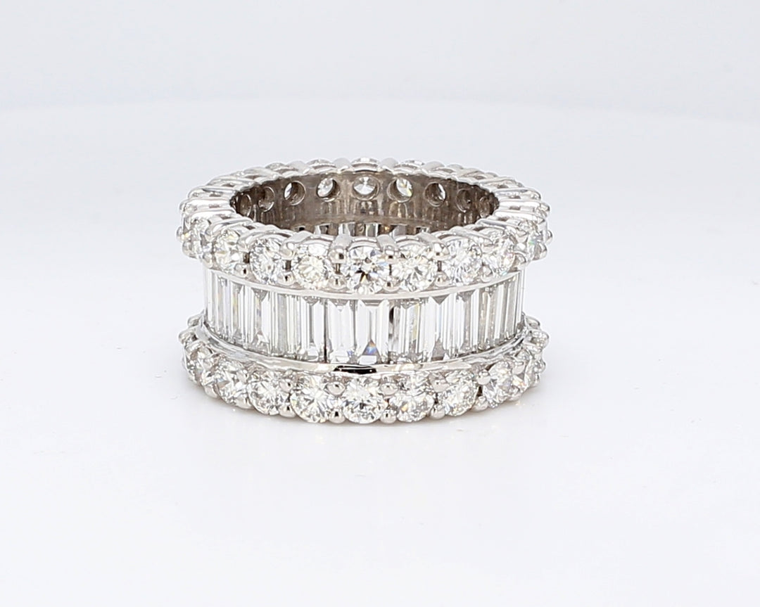 Eternity band in platinum with channel set baguettes in the center & prong set round diamonds on each side.  D8.72ct.t.w.  Size 6.75