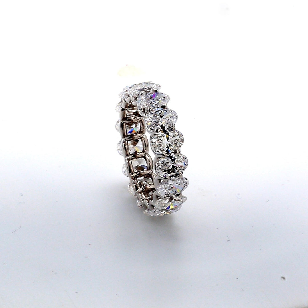 Eternity band in platinum with U-prong set GIA certified D-F/VVS1-VS1 (17) oval diamonds.  D6.89ct.t.w.  Size 7.25