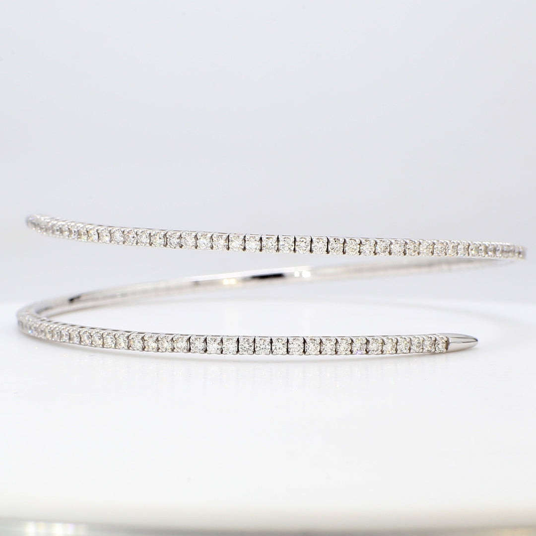 Flexible bangle in 18K WG with 4-prong set round diamonds.  D2.28ct.t.w.