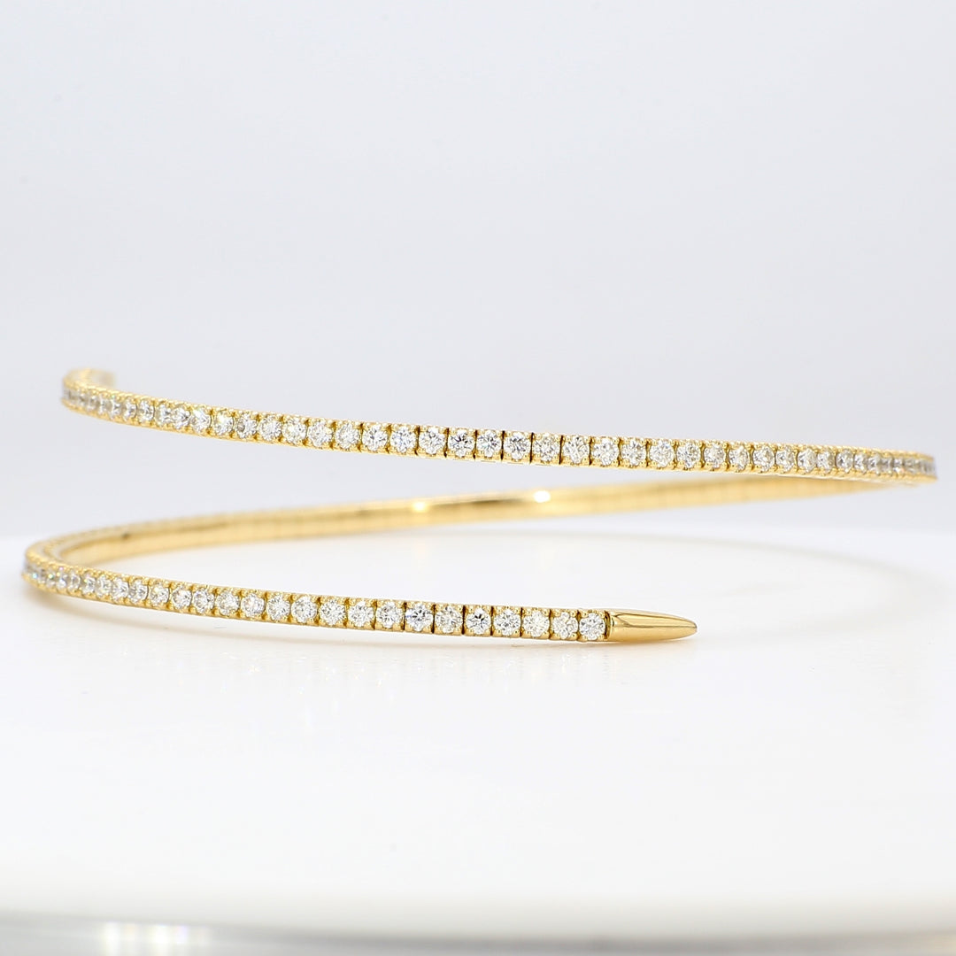 Flexible bangle in 18K YG with 4-prong set round diamonds.  D2.28ct.t.w.