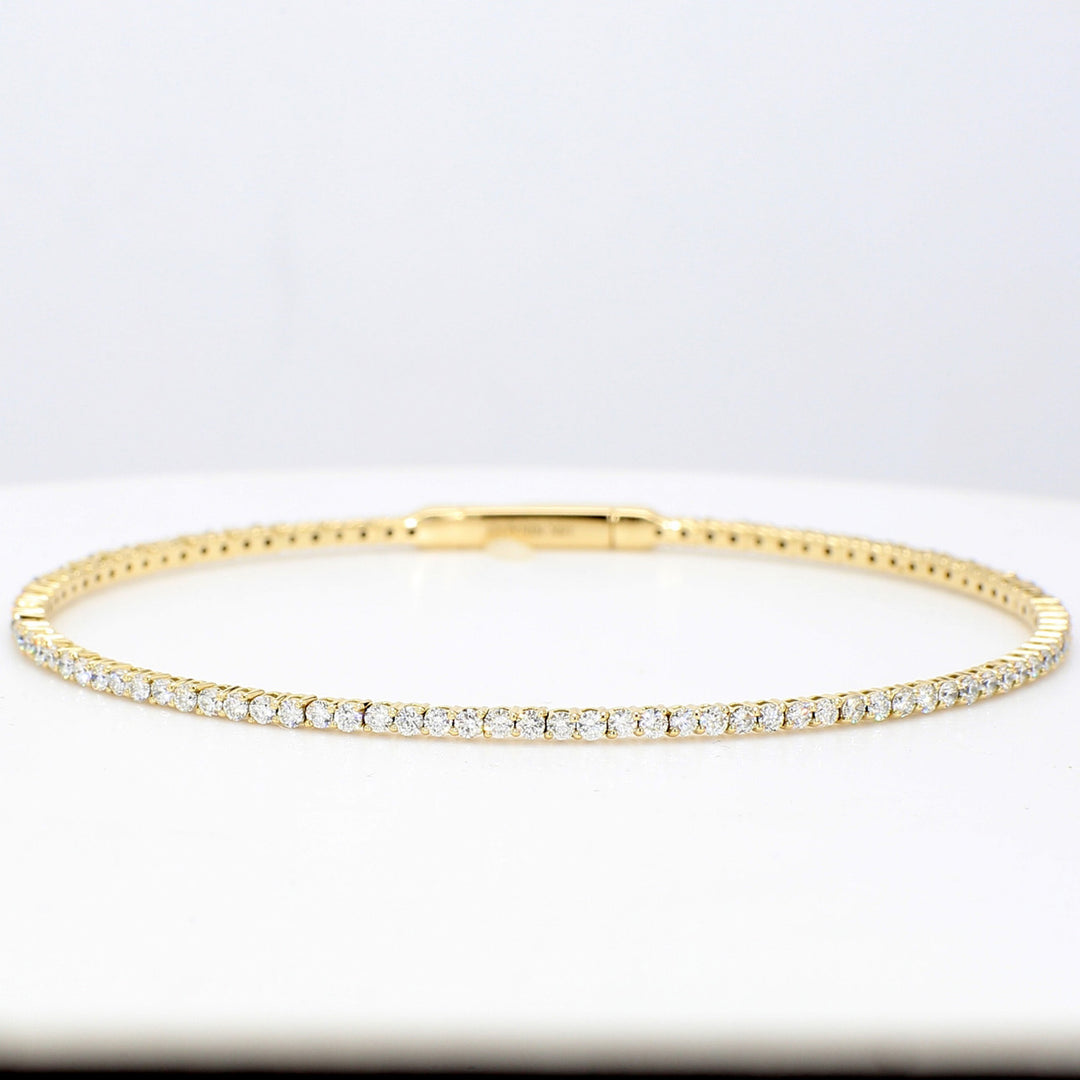Flexible oval shaped eternity bangle in 18K YG with French pave set round diamonds.  D1.63ct.t.w.
